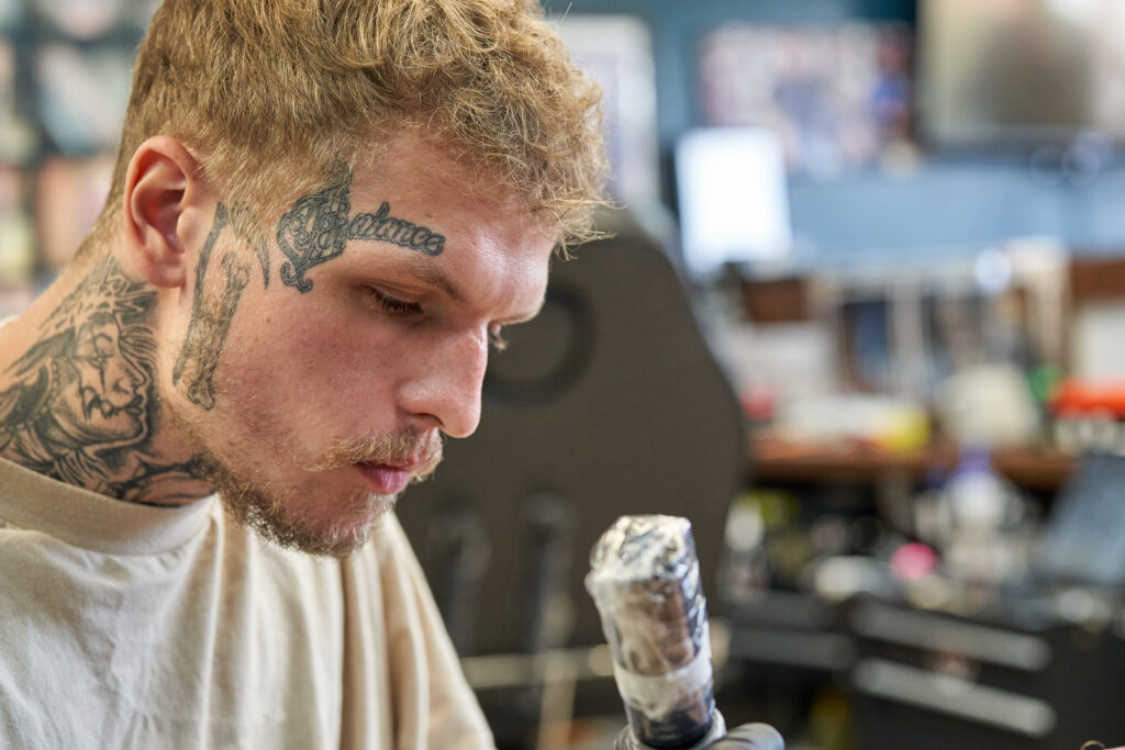 Owen Peat, a tattooist at Black Dagger Tattoo Norwich, working in the studio - Photography Blanc Creative Norwich