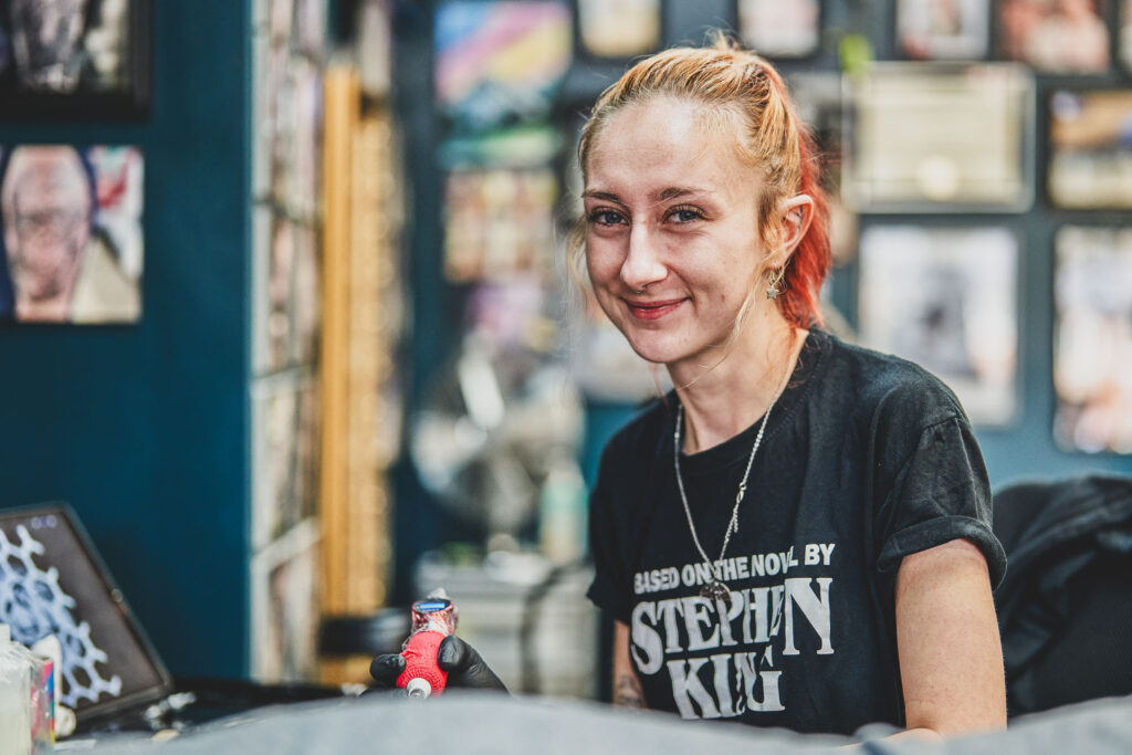 A headshot of Chantelle, a tattooist at Black Dagger Tattoo Norwich working in the studio.