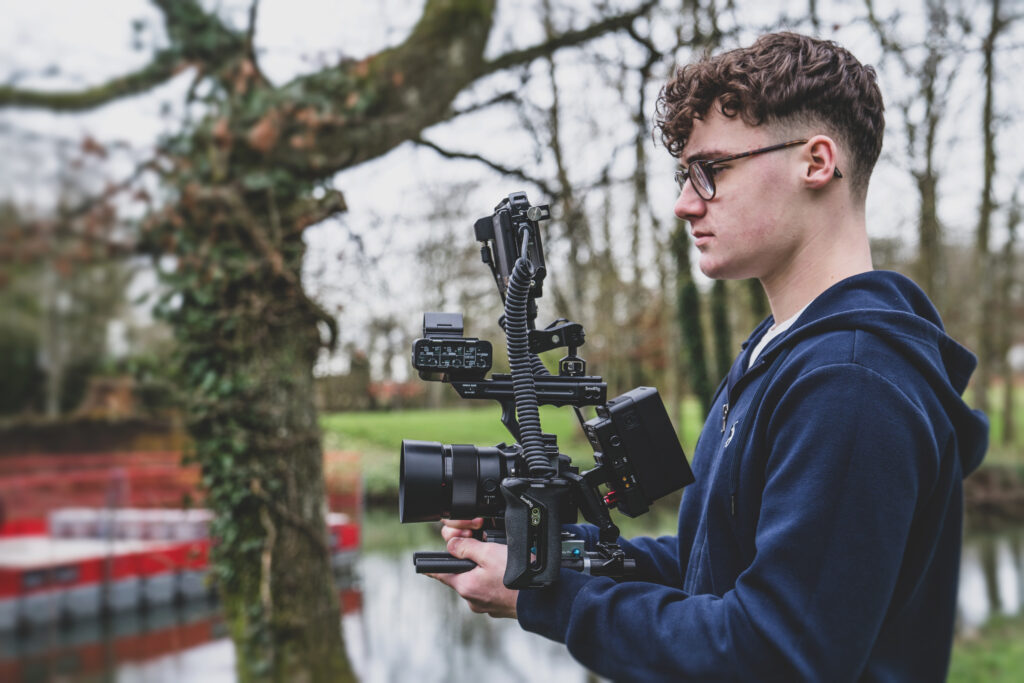 A Blanc Creative camera operator in Norwich holding a Sony FX3 video camera rig and filming