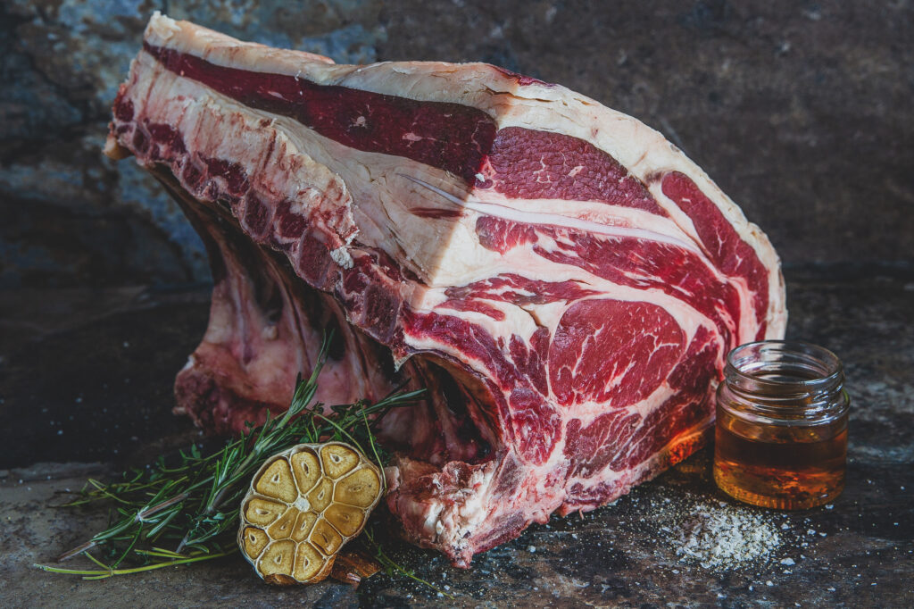 Food Photography Tips from Blanc Creative Norwich. A large piece of steak is photographed on a granite background using natural light and a reflector