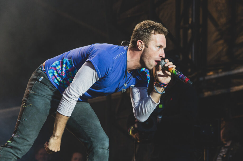 Chris Martin performs a lovely set on stage headlining with Coldplay at The Radio 1 Big Weekend concert at Powderham Castle in Exeter - Press Photography by Blanc Creative Norwich