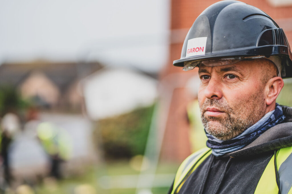 Commercial Headshot Photography of a construction worker on a building site wearing a safety hat - Professional Photography by Blanc Creative in Norfolk