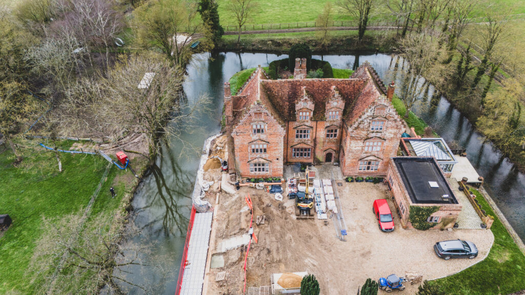 Drone Photography at Morley Old Hall of AJT Contracting operating a Alan Frosdick, using a large Yanmar Vi082 excavator expertly in confined space