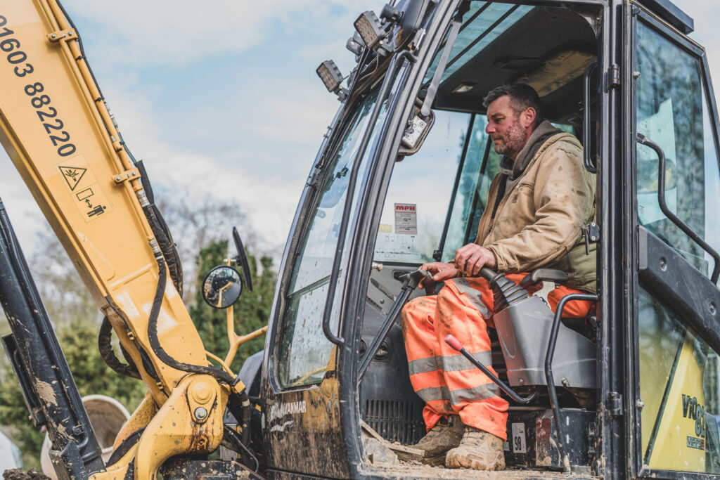 Alan Frosdick, owner of AJT Contracting Norwich, professionally operates a Yanmar Vi082 excavator expertly in confined space at Morley Old Hall.