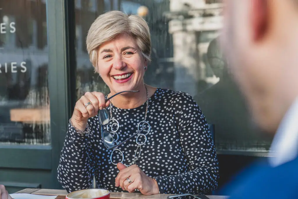 Female executive portrait, natural light, warm smile, professional services — business portrait photography London by Blanc Creative