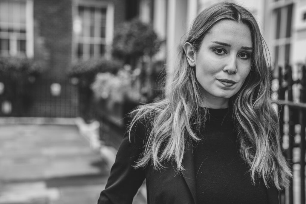A professional business portrait of a young female professional walking along a London Mews in Manchester Square - Photography Blanc Creative London
