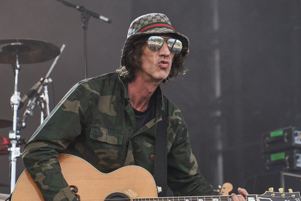 A close up portrait of Richard Ashcroft wearing sunglasses and a gucci bucket hat while performing n the Sandringham Estate, Norfolk - Blanc Creative Press Photography
