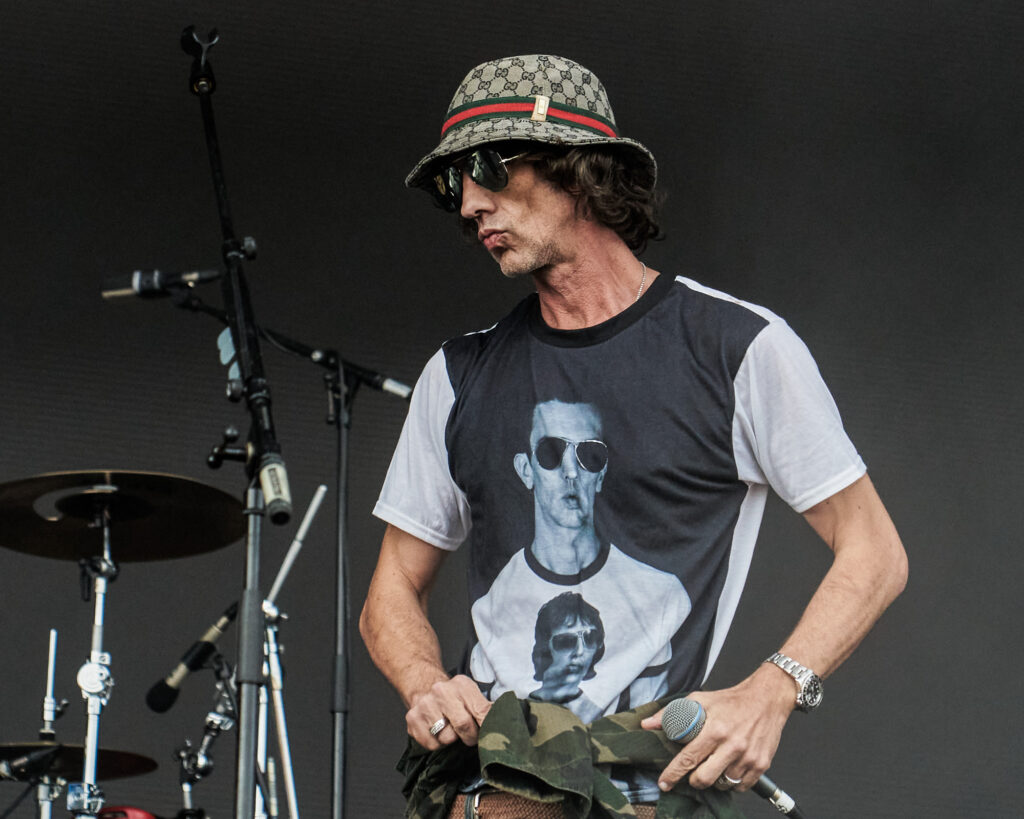 A close up portrait of Richard Ashcroft wearing sunglasses and a gucci bucket hat while performing n the Sandringham Estate, Norfolk - Blanc Creative Press Photography