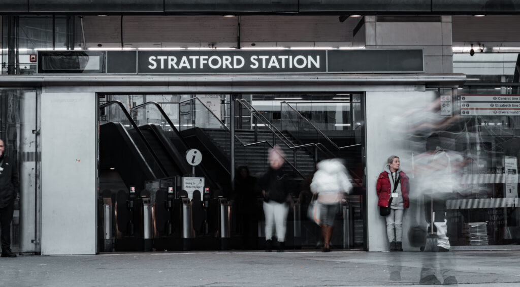 Stratford Station, in London with public quickly entering and leaving the station during rush hour