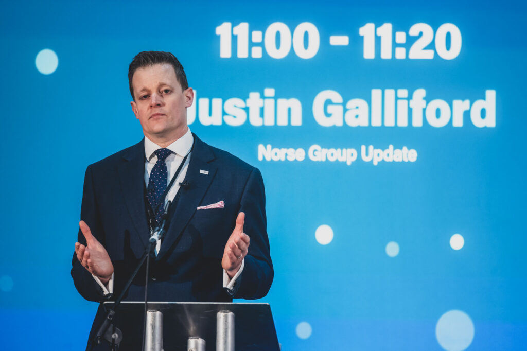 Event Photography Norwich showing Justin Galliford, CEO of Norse Group, speaking at a business conference - Blanc Creative Norwich Photographer