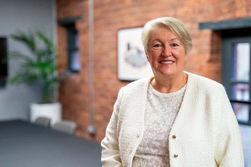 Female executive portrait, natural light, warm smile, professional services — business portrait photography London by Blanc Creative