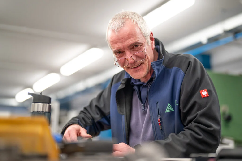 Blanc Creative Commercial Photography Norwich Male Engineer in industrial work envionment laughing during a corporate headshot session at Adapt Engineering Dublin