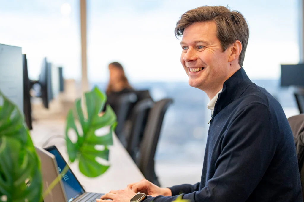 Blanc Creative Commercial Photography Norwich Recruitment Photography - Professional business portrait of a man in natural light at a desk using laptop - Blanc Creative Norwich