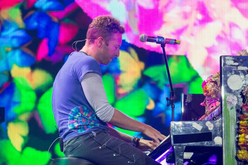 Blanc Creative Commercial Photography Norwich Working for Exposure - Why It Doesn't Pay the Rent. Chris Martin and Coldplay headlines a festival. He sit at a piano.