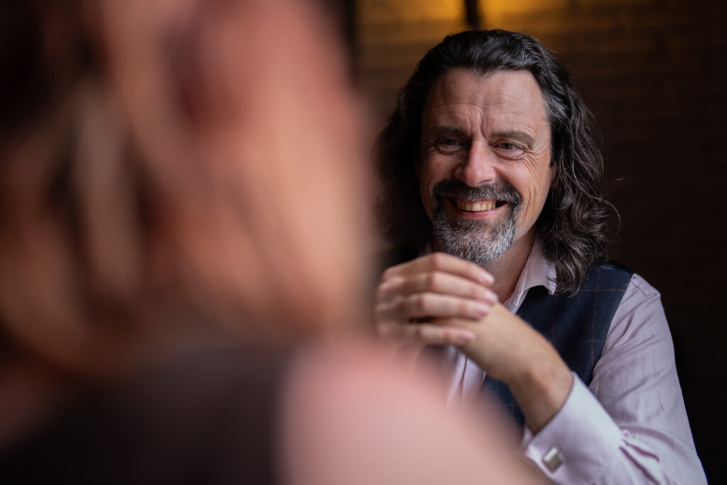 Dr Danny Kett of Rebelbridge Studio in conversation, natural light portrait in a Norwich café